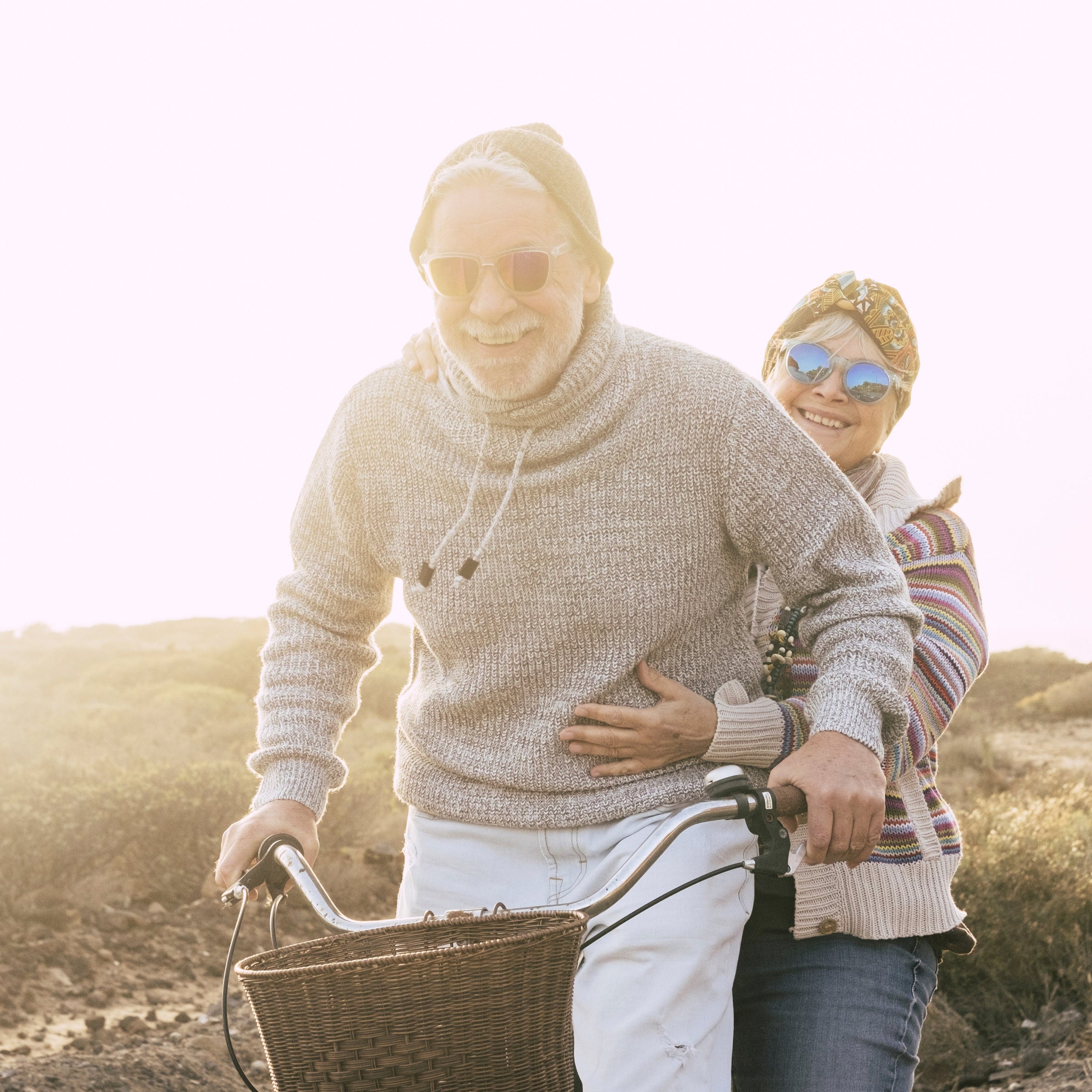 Two elderly people on a bicycle - sun and fun